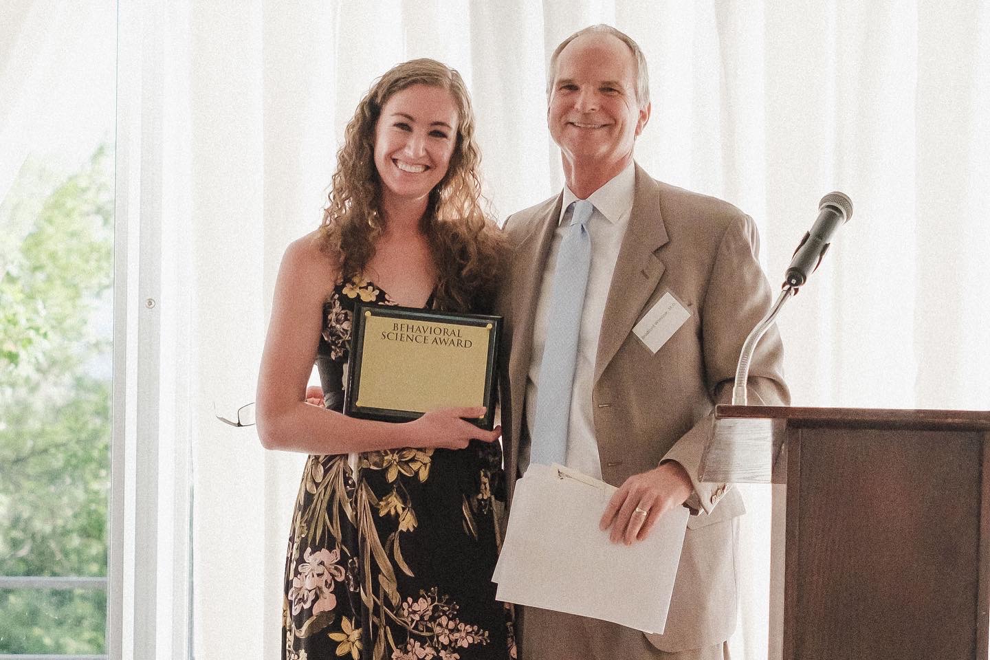 Dr. Lindsay Ogle receives award from Family Medicine program director at graduation.